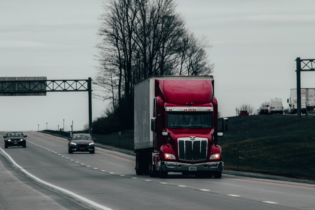 red-and-white-truck-on-road-during-daytime-xmwlqeytcqq